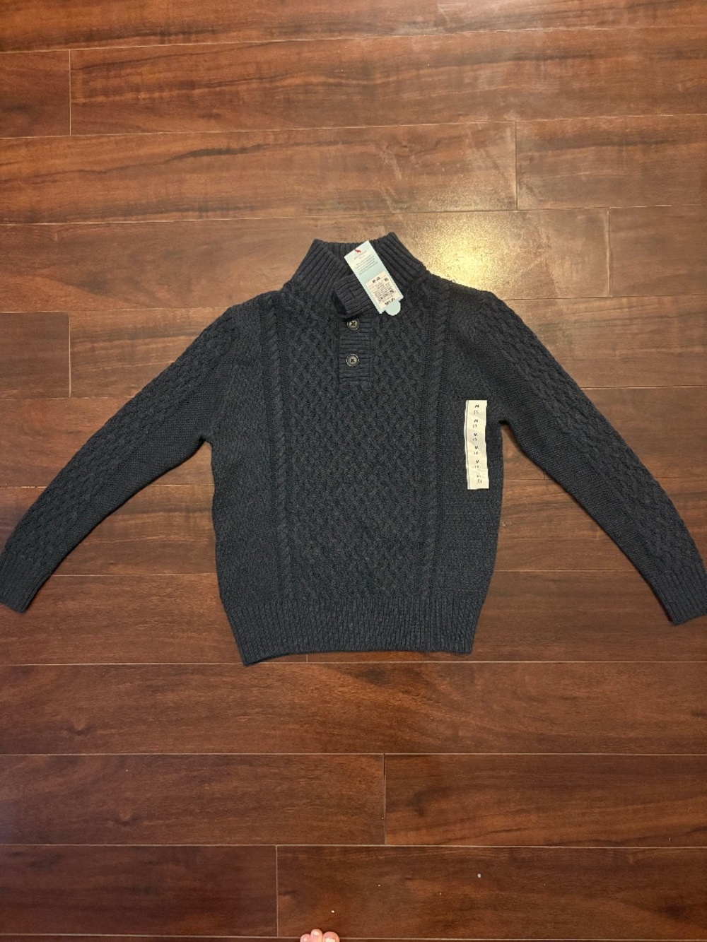 navy knit sweater with cross stitch